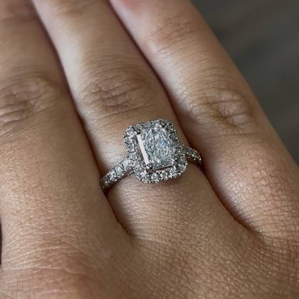 Radiant cut diamond halo ring worn on the hand