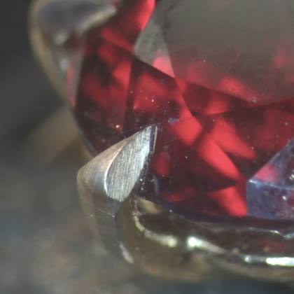 Red gemstone macro shot showing claw setting detail
