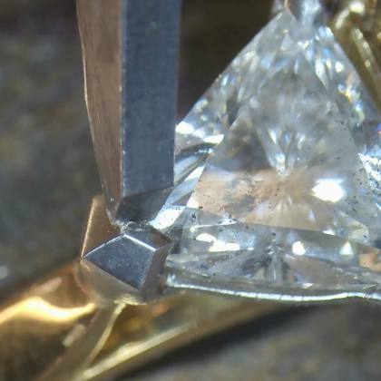Trillion cut diamond claw setting close up