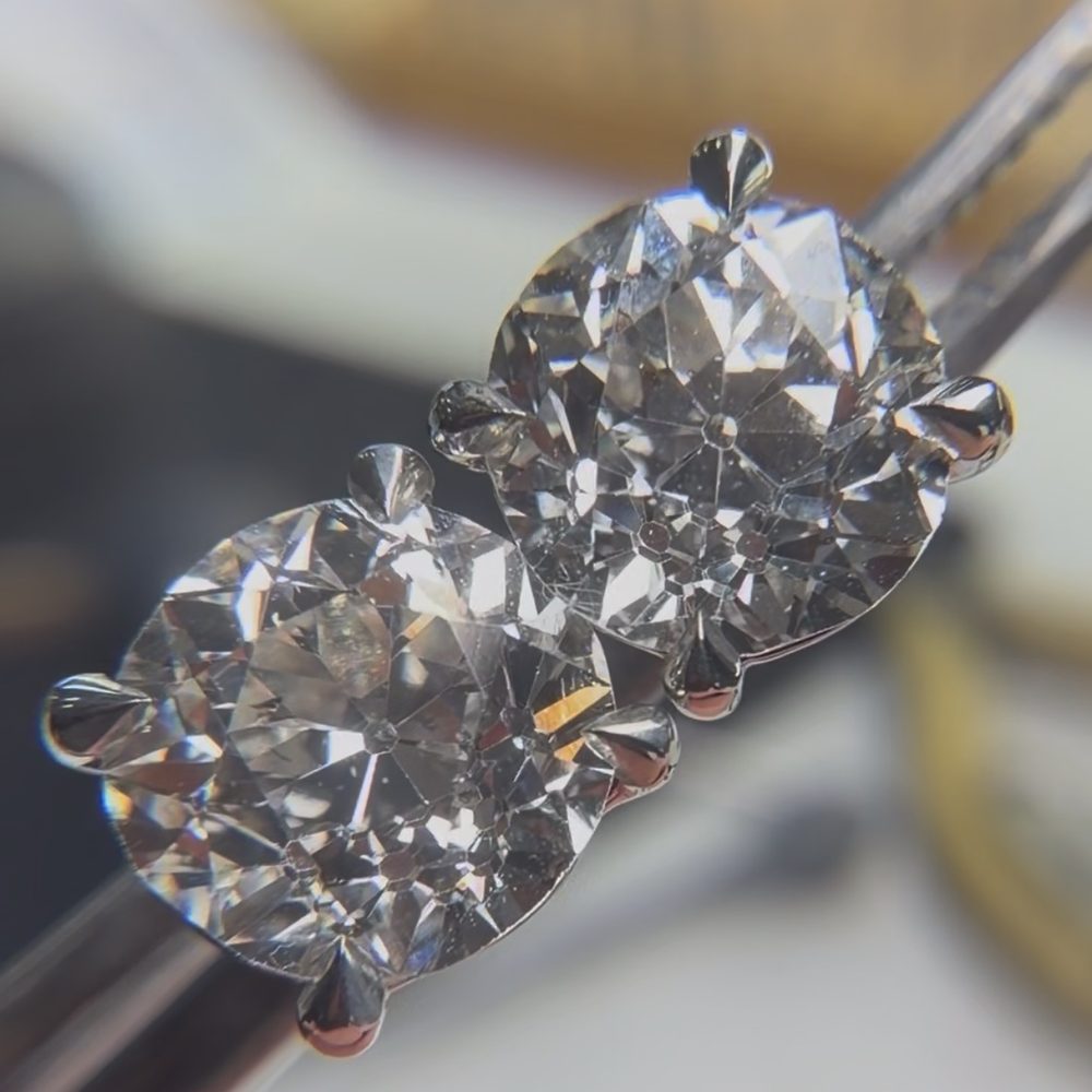 A pair of old cut diamond stud earrings, four claw set in white metal